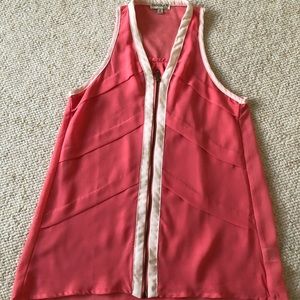 Blouse it’s lots of details. Color is coral with beige piping. Very slimming.